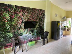 a dining room with a wall with a mural of flowers at Apartment in Plaza Europa in Sosúa