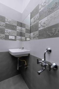 a bathroom with a sink and a mirror at VALUE INN in Bangalore +69 photos