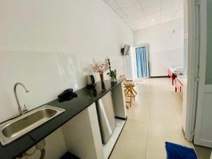 a kitchen with a sink and a counter top at Lac House Mui Ne in Mui Ne