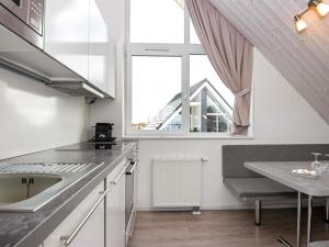 a kitchen with a sink and a window at Two-Bedroom Holiday home in Wendtorf 34 in Wendtorf