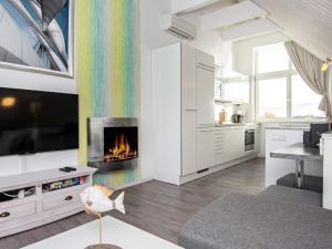 a living room with a fireplace and a rainbow wall at Two-Bedroom Holiday home in Wendtorf 38 in Wendtorf