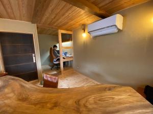 a room with a person sitting at a desk with a laptop at 体験型古民家宿 旅ノ舎 in Nissaka