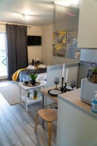 a room with a bed and a kitchen with a table at Meni Sweet Central Studio in Volos