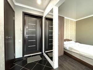 a bedroom with a bed and a large mirror at 1-комнатная квартира, центр, супермаркет Сокол in Petropavlovsk +4 photos