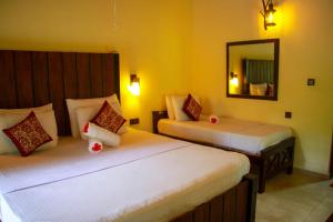 Katil atau katil-katil dalam bilik di Machcha Lodge Sigiriya