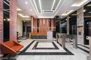 a lobby with a brick wall and a table and chairs at PRO HOME SUİTES in Istanbul