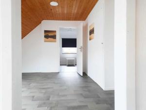 a hallway with white walls and a wooden ceiling at Work & Stay in Kranenburg near Kleve in Kranenburg