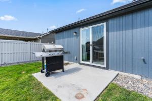 a barbecue grill sitting in the backyard of a house at Urban Boho Caldwell 3 Bedroom Great for Families! in Caldwell