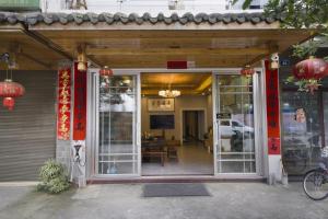 an entrance to a restaurant with a glass door at Qianxun Tea House & Homestay in Wuyishan