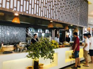 a group of people standing in a restaurant kitchen at Diamond Bay Condotel Resort Nha Trang in Nha Trang