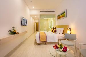 a hotel room with a bed and a table at Diamond Bay Condotel Resort Nha Trang in Nha Trang