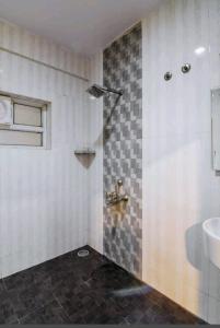 a bathroom with a sink and a toilet and a shower at Royal shades kodihali in Bangalore