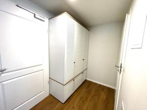 a closet with a white cabinet and a door at Baltic Lagoon Resort - Appartement 12 in Fuhlendorf