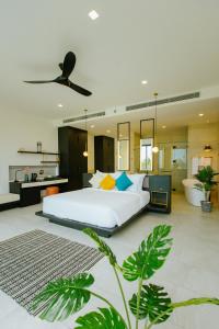 a bedroom with a large bed and a bathroom at Perolas Villas Resort Powered by ASTON in Phan Thiet