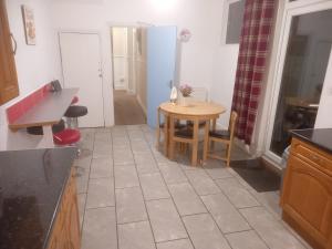 a kitchen with a table and a small table and chairs at 52 Cambrian St in Aberystwyth +9 photos