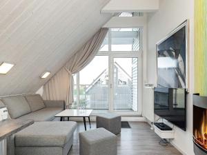 a living room with a couch and a tv at Two-Bedroom Holiday home in Wendtorf 3 in Wendtorf