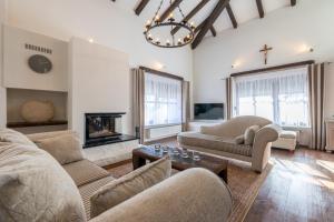 a living room with two couches and a fireplace at Kuca za odmor M11 in Kupres