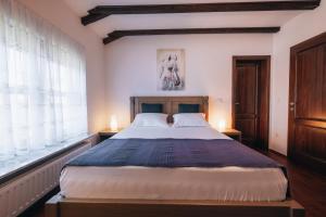 a bedroom with a large bed and a window at Kuca za odmor M11 in Kupres