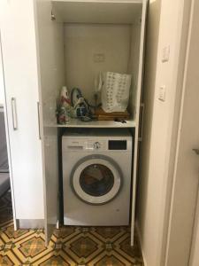 a washer and dryer in a small room at Charming apartment in Tel Aviv in Tel Aviv