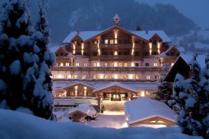 a large hotel in the snow at night at Grossarler Hof Superior in Grossarl