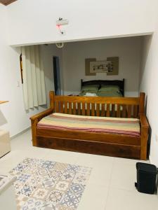 a bedroom with a wooden bed in a room at Rancho Cavalo Mania in São Roque