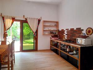 a kitchen with a counter and a table with a microwave at Culture's apartment in Paje