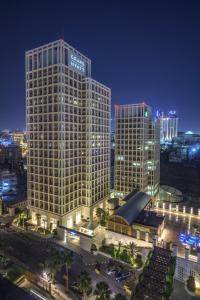 a view of a large building in a city at night at Grand Hyatt Amman Residences in Amman