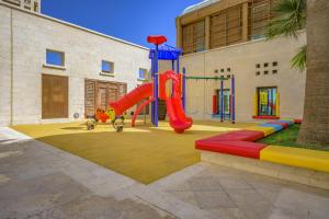 a playground with a slide in a building at Grand Hyatt Amman Residences in Amman