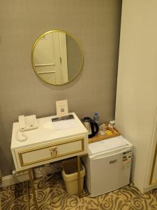 a bathroom with a vanity and a mirror on the wall at Mr BEYAZ HOTEL in Istanbul