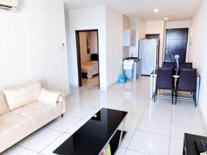 a living room with a couch and a table at Vesta Homes, KSL Residences Taman Daya, Johor Bahru in Johor Bahru