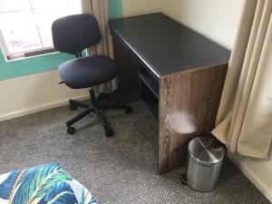 a desk and a chair in a room at Pahoa Village Hostel in Pahoa