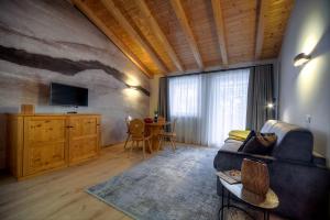 a living room with a couch and a table at Eden Apartments in Siusi