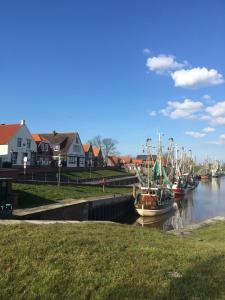 a group of boats are docked in a harbor at Kapitänshaus mit Hafenblick in Greetsiel