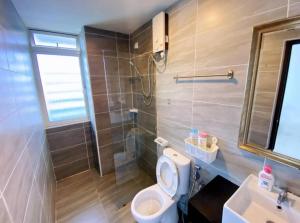 a bathroom with a toilet and a shower and a sink at Vesta Homes, KSL Residences Taman Daya, Johor Bahru in Johor Bahru +5 photos