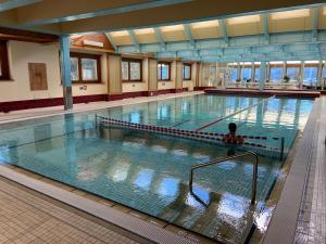 a large swimming pool with a person in the water at La Ruinette - Mondzeu 259 in Verbier