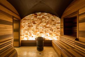 a sauna with a brick wall and a fire place at Limmathof Baden - Historisches Haus & Spa in Baden