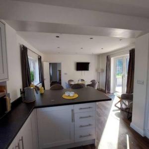 a kitchen with a counter top and a living room at The Lodgings 3 Bed Cottage suitable for families breaks, working away Lincoln in Laneham