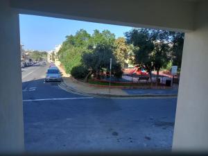 a view of a street with a car on the road at Cosy 1 bedroom studio flat in Gudja