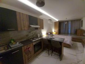 a kitchen with a sink and a bed in a room at Cosy 1 bedroom studio flat in Gudja