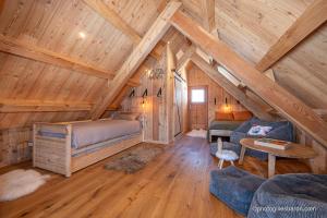 a room with a bed and a couch in a cabin at Le Refuge Ibex - Chalet d'Alpage au coeur de la nature - 8 personnes in Orcières