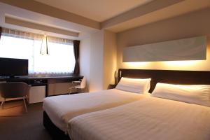 En eller flere senge i et værelse på KOKO HOTEL Numazu Inter