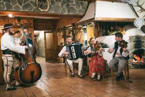 a group of men playing music in a room at Bacówka Biały Jeleń in Iwkowa