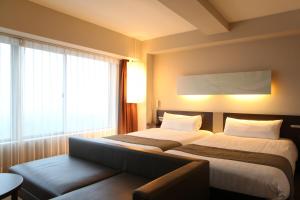 En eller flere senge i et værelse på KOKO HOTEL Numazu Inter