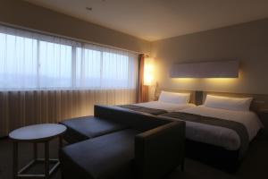 En eller flere senge i et værelse på KOKO HOTEL Numazu Inter
