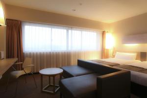 En eller flere senge i et værelse på KOKO HOTEL Numazu Inter