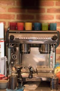 een koffiezetapparaat met kleurrijke kopjes erop bij The Castle Bar ROOM ONLY in Cambridge