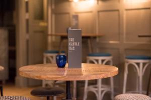 a table with a blue glass sitting on top of it at The Castle Bar ROOM ONLY in Cambridge