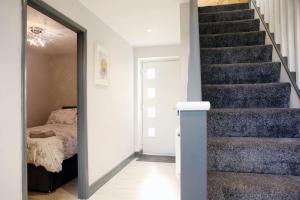 a bedroom with a staircase with a bed and a mirror at The perfect stay, 2 bedroom, great location. 