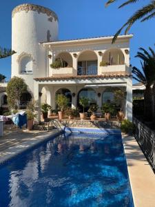 a large house with a swimming pool in front of it at Casa BOWA in Hospitalet de l'Infant