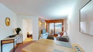 una sala da pranzo e un soggiorno con tavolo di Abitaziun Caspar Badrutt 306 - St Moritz a Sankt Moritz